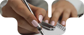 Close-up of hands writing in a notebook, representing documentation and legal consultation